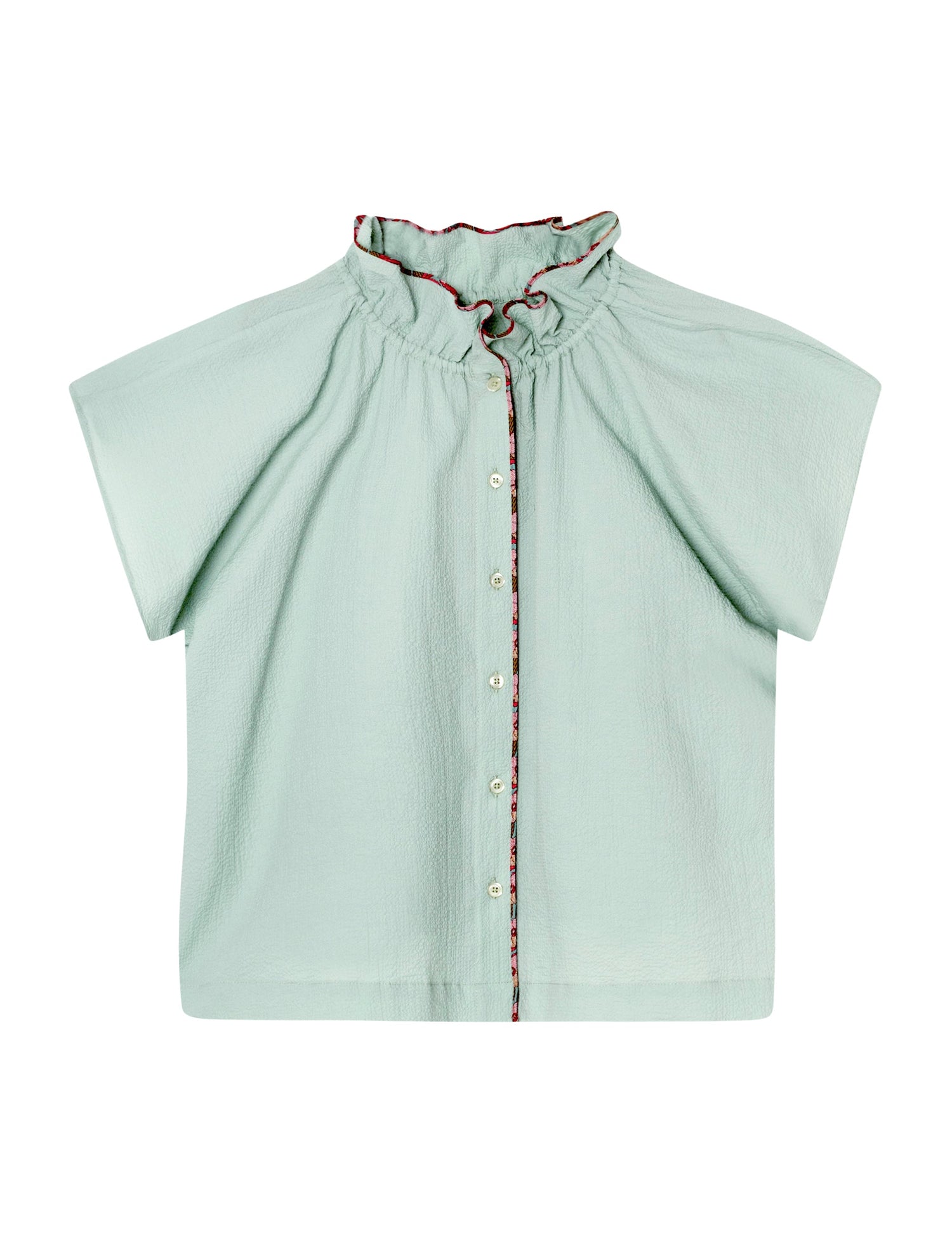 En lysegrøn, kortærmet bluse med en rynket krave og knapper ned foran ligger fladt på en hvid baggrund. Blomstret kant pryder kraven og knaplukningen.